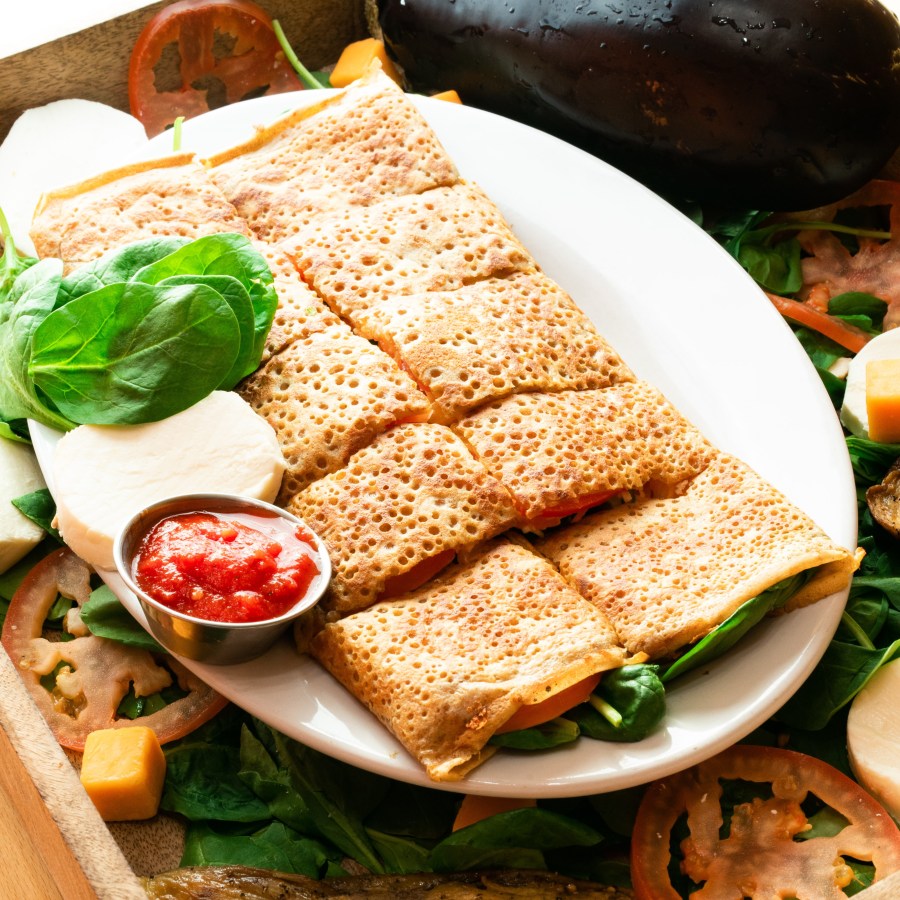 Fresh savory crepe with spinach and vegetables